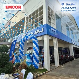 Blue and white Bajaj 3S Shop storefront with an EMCOR sales, service, and spare parts sign and a balloon arch at the entrance