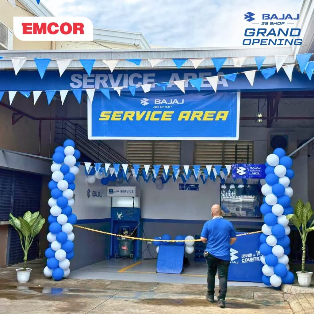 Bajaj Service Area entrance decorated with blue and white balloons and pennants