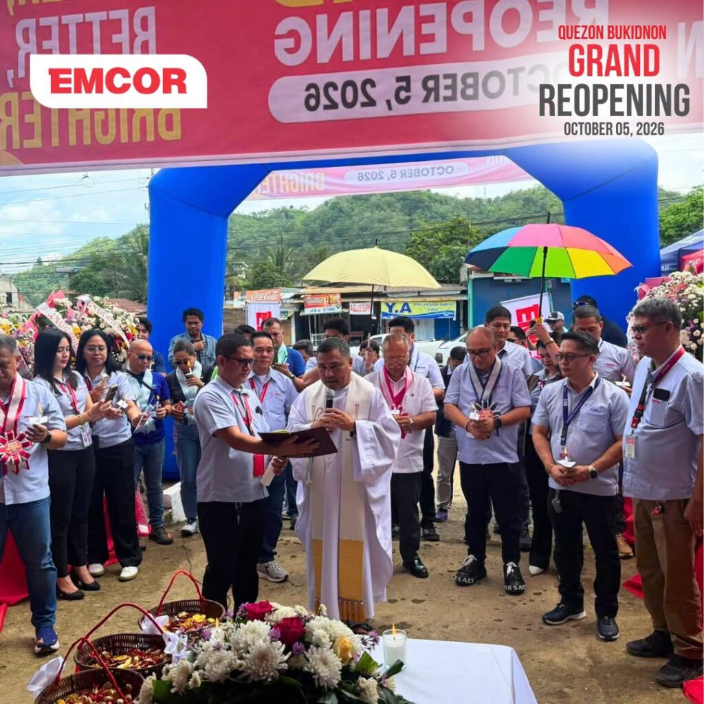 Priest blessing the reopened EMCOR store in Quezon, Bukidnon as employees and guests look on